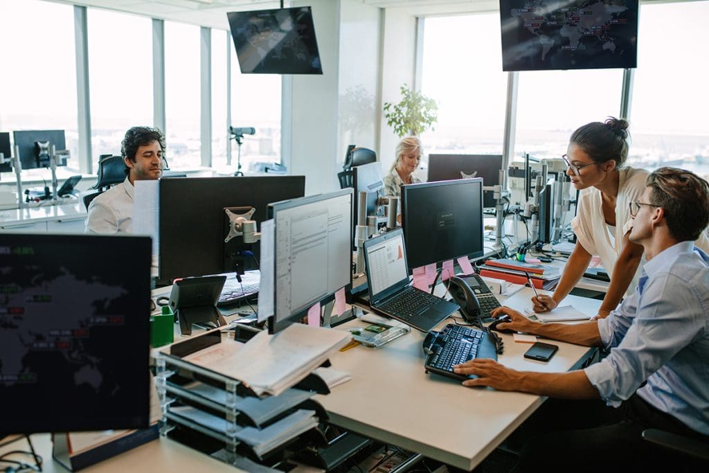 People busy working on computers in an office.