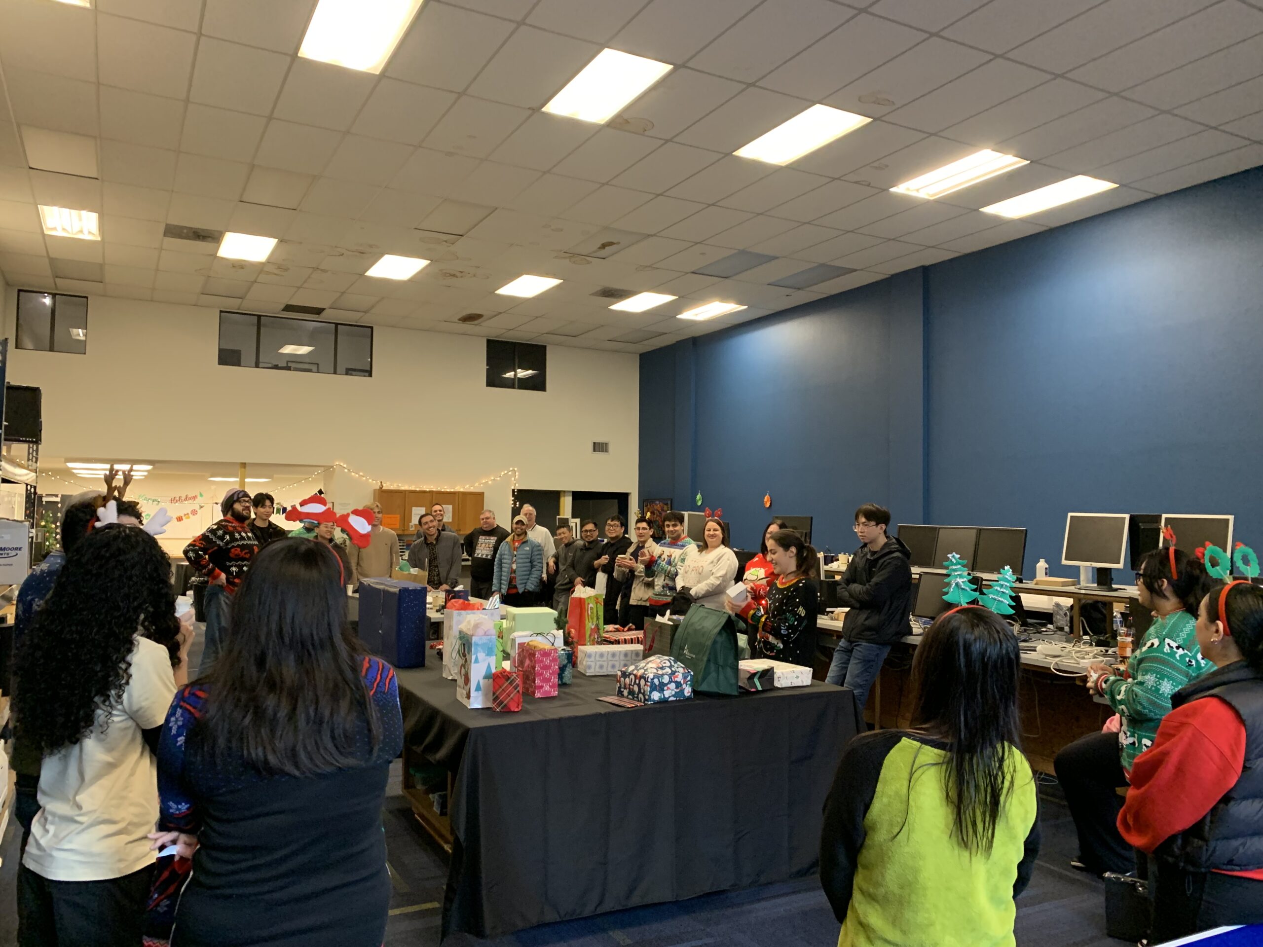 The PC Professional team playing White Elephant, dressed in their holiday attire.