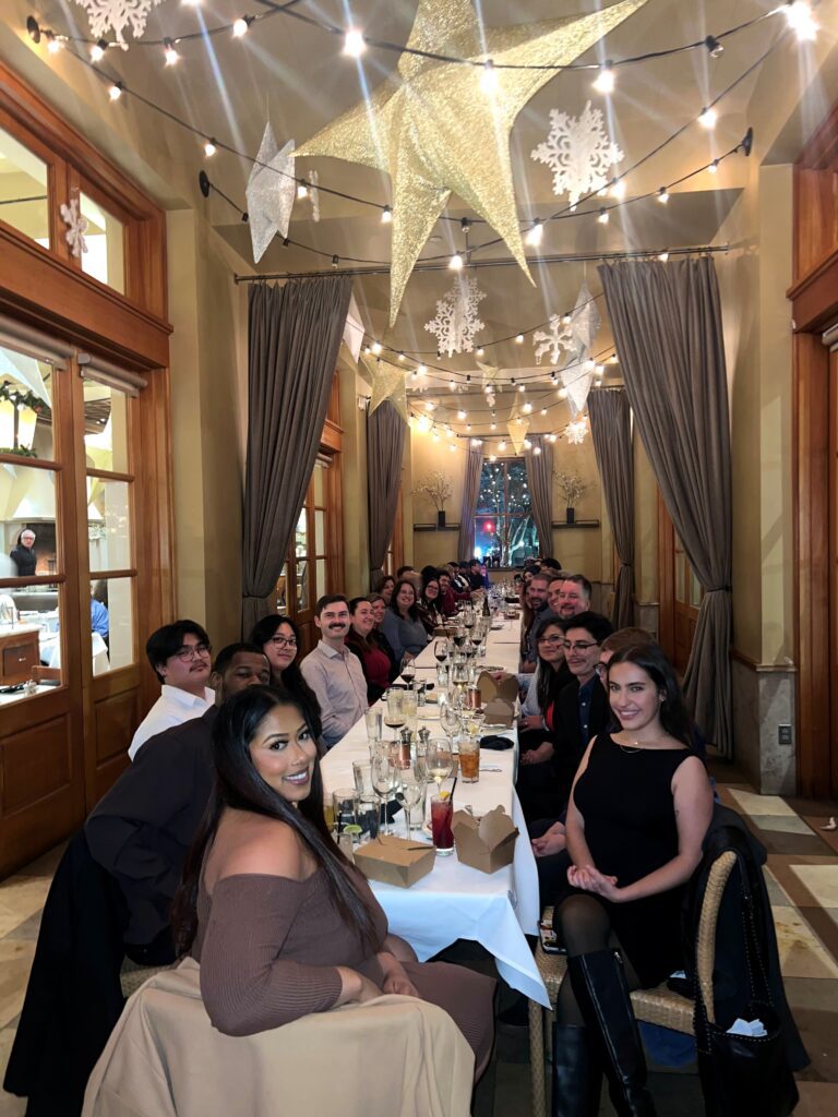 The PC Professional team sitting at a long dinner table.