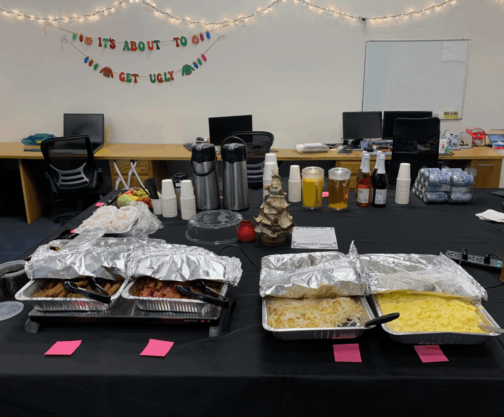 The breakfast spread of eggs, hashbrowns, sausage, bacon, bagels, french toast, as well as a variety of fruits and drinks.