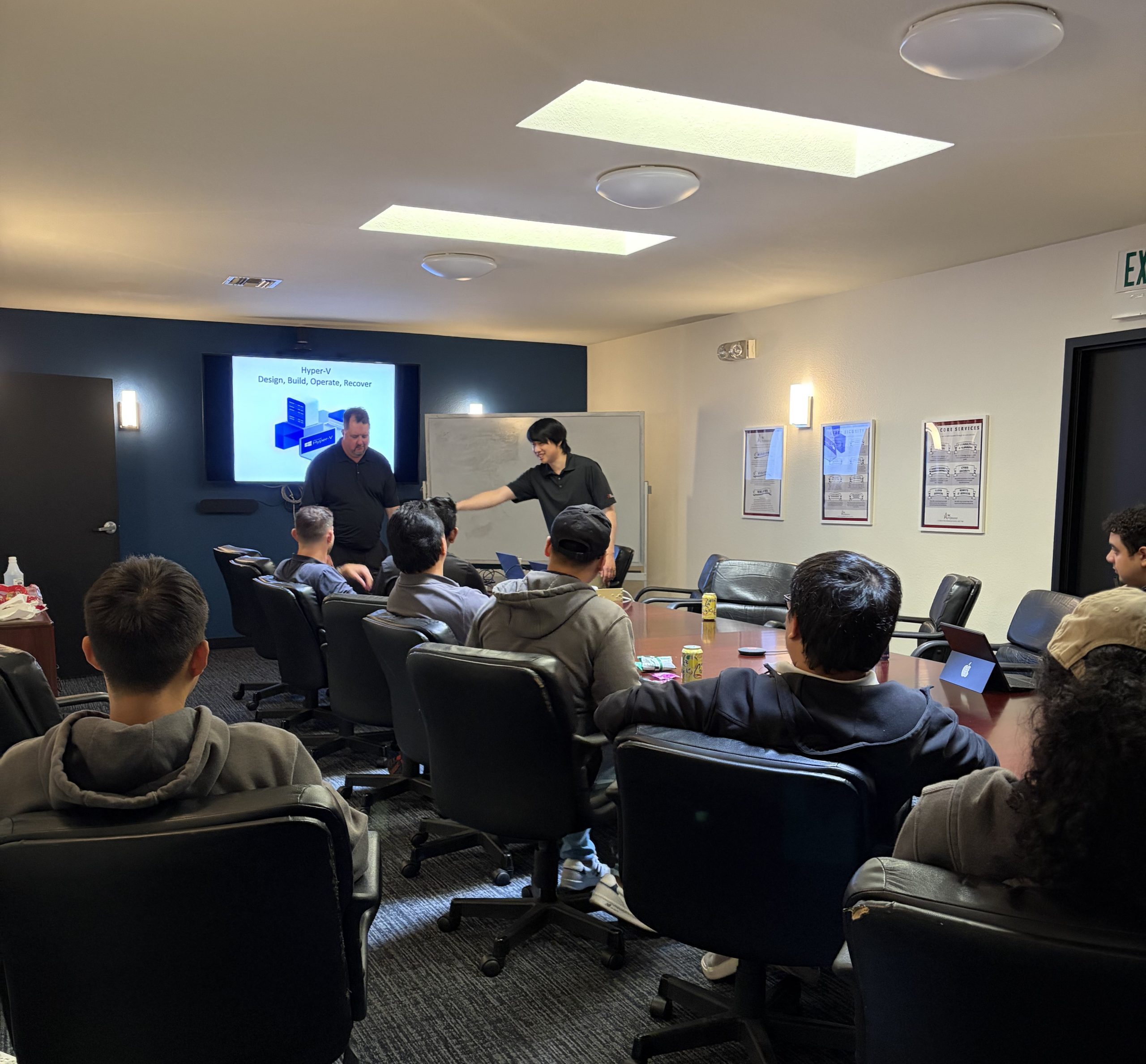 PC Professional engineers watching a presentation by the senior engineers.